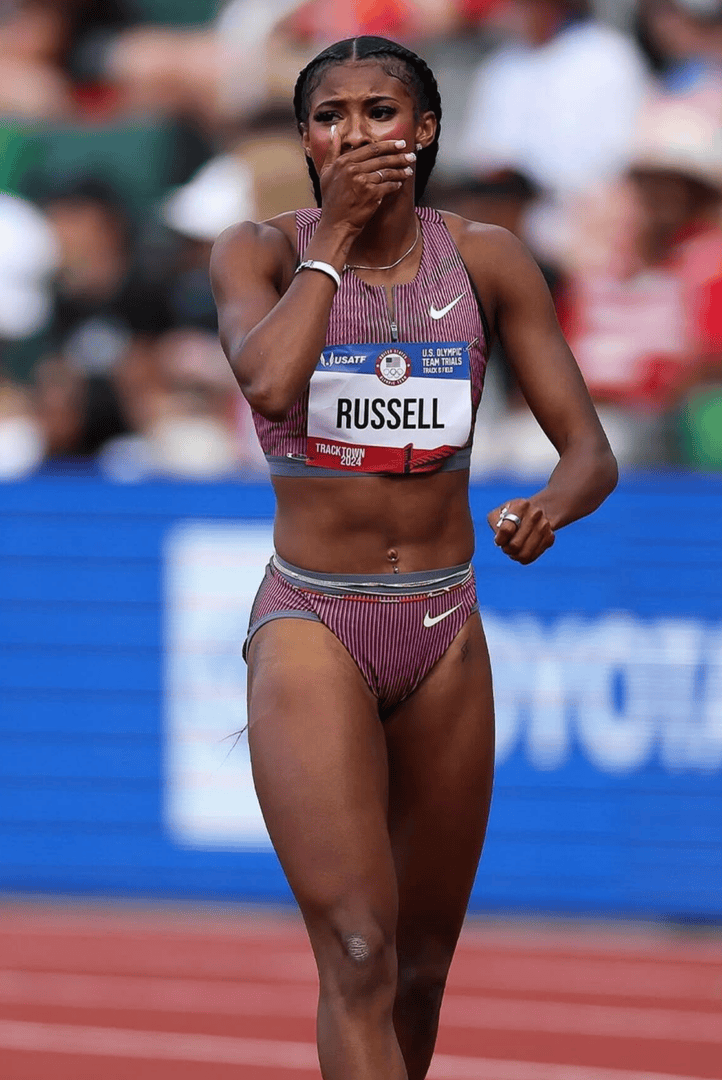 Athlete on track covering mouth
