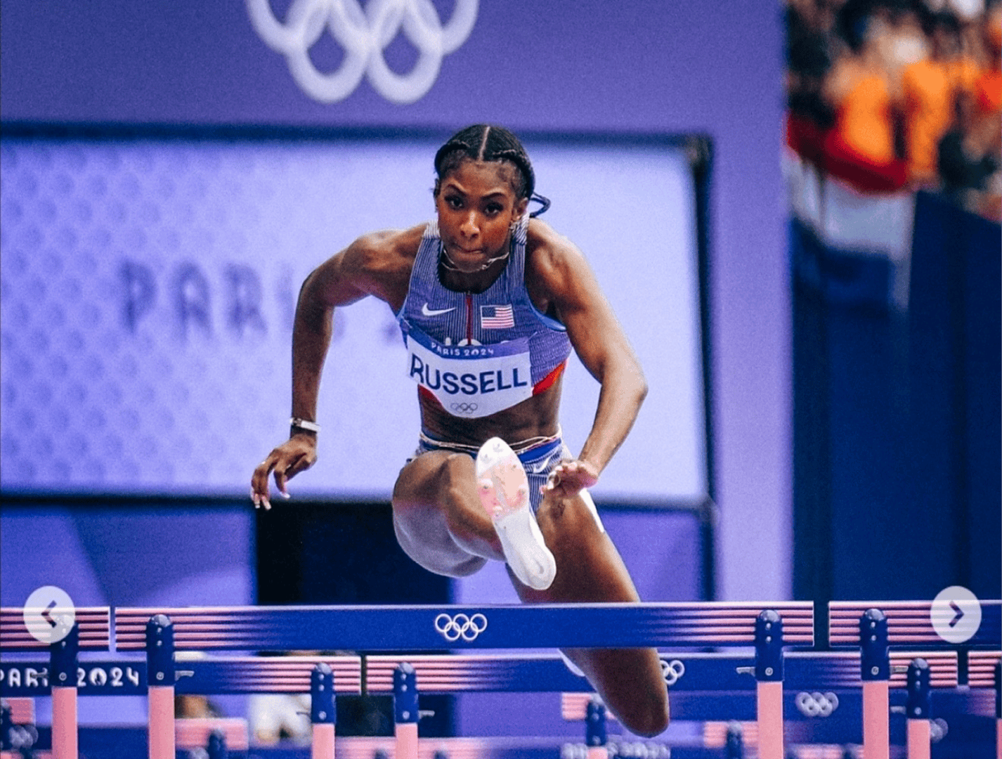 Athlete hurdling in Olympic competition
